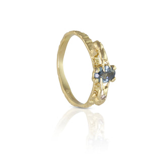 Alternative engagement ring with blue sapphire and champagne diamond
